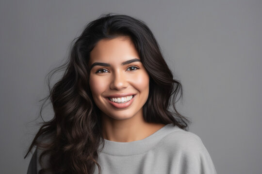 Portrait of a smiling latin woman isolated on a gray background. AI
