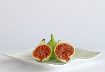 Naklejka na ściany i meble Fresh Green Figs on a Plate isolated on white in Mersin, Turkey 
