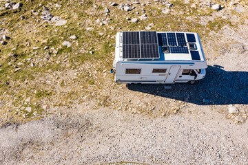 Caravan solar panels on roof camping on nature. Aerial view