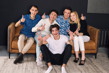 Group photo of a happy friends sitting on a couch in a living roon. small group of friends photo.