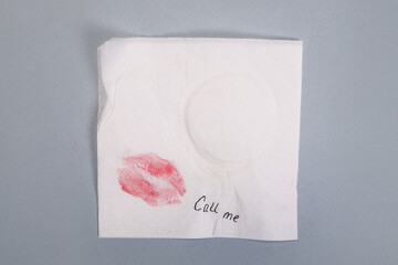 Napkin note with text call me and kisses