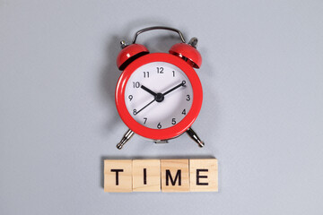 Time word and red alarm clock