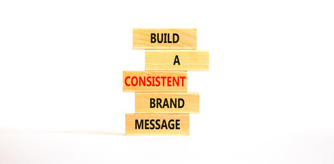 Consistent brand message symbol. Concept words build a consistent brand message on wooden blocks. Beautiful white table white background. Business consistent brand message concept. Copy space.