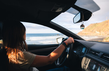 Fototapeta na wymiar Woman driving a car at the coast