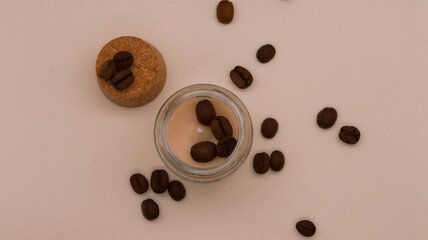 coffee beans on top of an aromatic candle