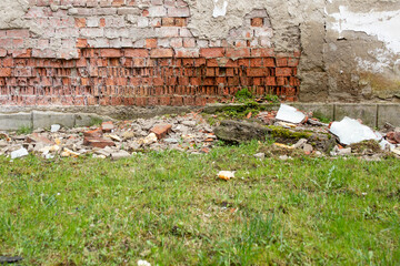 Collapsing wall due to water infiltration, red brick wall deteriorated