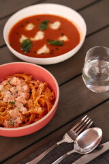 Table of italian meals on plates Pizza, pasta, ravioli, carpaccio, mushroom risotto, caprese salad and tomato bruschetta on rustic wooden background. Top view. Flat lay