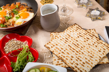 A fragment of a set table for the Passover seder matzah, maror and other treats.
