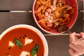 Table of italian meals on plates Pizza, pasta, ravioli, carpaccio, mushroom risotto, caprese salad and tomato bruschetta on rustic wooden background. Top view. Flat lay