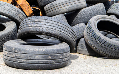 Industrial dump for the processing of used tires and rubber tires. Pile of old tires and wheels for...