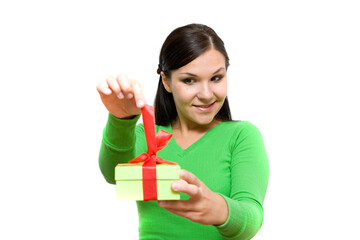 attractive brunette woman holding gift on white background