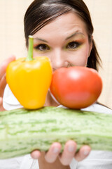 attractive brunette woman holding vegetable