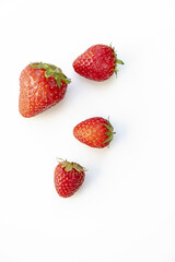 Group of four strawberries viewed from above on a white background