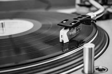 Close up black and white photo of  a record's player needle on a record.