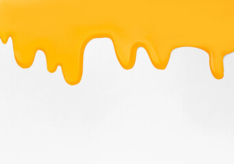 Pouring honey on a yellow background copy space.