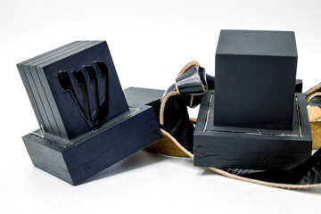 Tefillin  or  phylacteries . Pair of black leather boxes  for the arm and for the head with leather strips containing Torah verses that are worn Jewish men  prayers.  One box with hebrew letter Shin.
