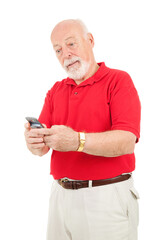 Senior man trying to figure out how to text with his new cell phone.  Isolated on white.