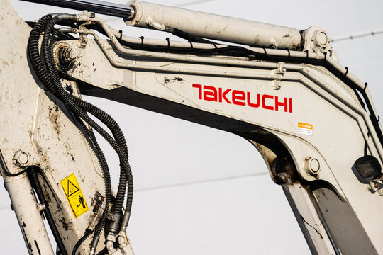 Gothenburg, Sweden - February 12 2023: Arm and hydraulics of a Takeuchi excavator.