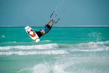 A kitesurfer displaying his skills in the sport