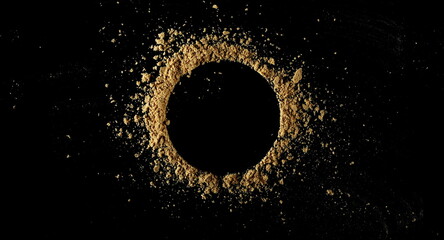 Ginger root powder isolated on black, top view