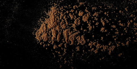 Fototapeta na wymiar Coriander powder pile isolated on black, top view 