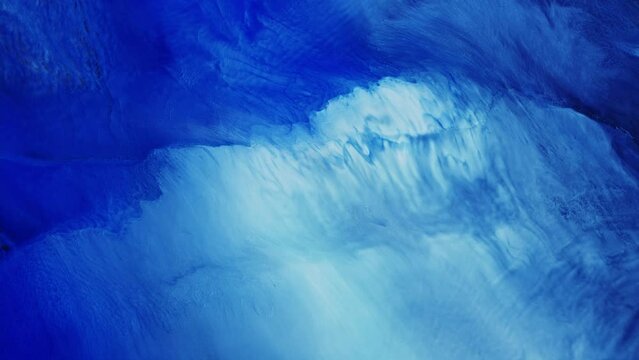 Fluid art. Abstract background with effect sea waves. Backdrop similar to the landscape of the ocean. Liquid artistic texture motion with blue and white colors.
