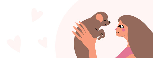 Woman in a trendy style holding a puppy. Girl and her pet.