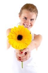 Beautiful angelic woman with flower in her hands - focus is on the flower