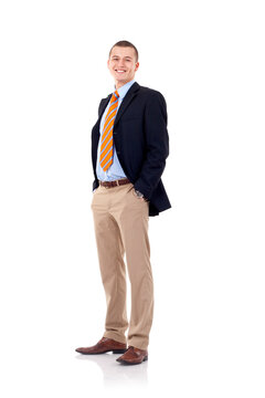 full body picture of a smiling business man standing with hands in pockets