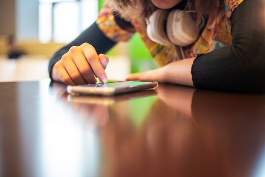 watch the news on the phone that is on the table. everyday life