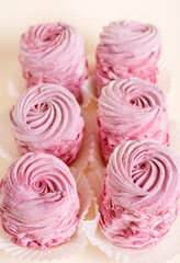 tasty delicious homemade zephyr pink marshmallows with blackberries taste.sweet dessert in box,on kitchen towel,gray tiles surface.whisk tea strainer accessories,sugar powder.pattern close up texture