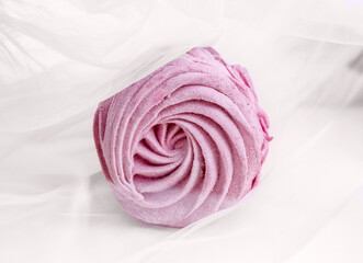 tasty delicious homemade zephyr pink marshmallows with blackberries taste.sweet dessert in box,on kitchen towel,gray tiles surface.whisk tea strainer accessories,sugar powder.pattern close up texture