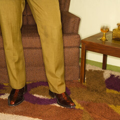 Close-up of standing Caucasian mid-adult male legs in vintage clothing.