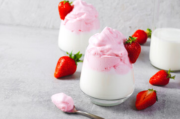 Whipped Strawberry Milk, Strawberry Milkshake, Dalgona Style Drink with Fresh Strawberry on Grey Background
