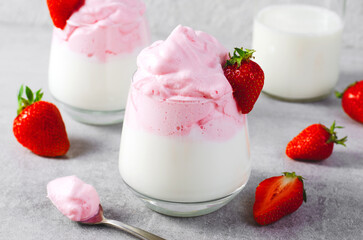 Whipped Strawberry Milk, Strawberry Milkshake, Dalgona Style Drink with Fresh Strawberry on Grey Background