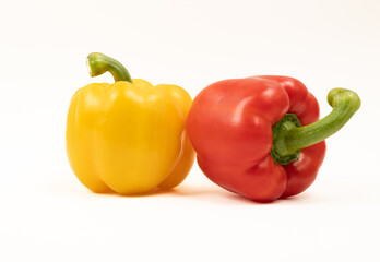 Red and yellow peppers close-up on white.