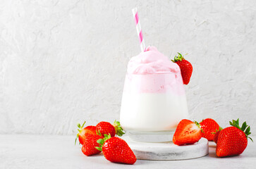 Whipped Strawberry Milk, Strawberry Milkshake, Dalgona Style Drink with Fresh Strawberry on Grey Background