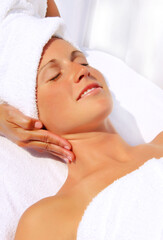 Fototapeta na wymiar Pretty woman receiving massage at a outdoor spa