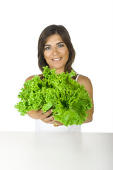 Beautiful young woman holding a healthy lettuce on her hands