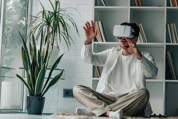young man at home with virtual reality glasses