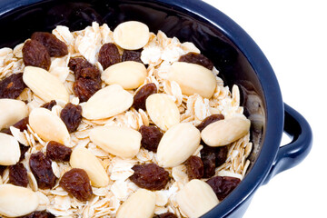 a bowl of oatmeal with raisins and almonds - healthy diet