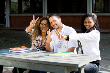 group of young african american college students giving thumbs up