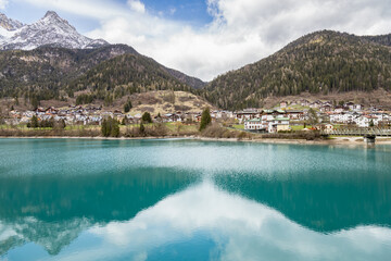 Beautiful view of reflections on Auronzo Lake turquoise water, in Auronzo di Cadore village; Belluno, Dolomites, Italy