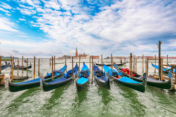 Captivating  landscape with Church of San Giorgio Maggiore on background and gondolas parked beside...