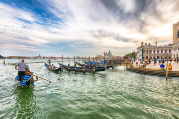 Fototapeta na wymiar Captivating landscape of Riva degli Schiavoni with parked gondolas in Venice. Popular tourist destination.