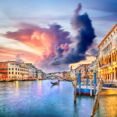 Amazing sunset and evening cityscape of Venice with famous Canal Grande and Rialto Bridge
