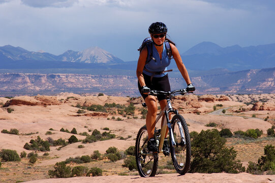 Woman mountain biking on the slick rock trail near Moab, Utah