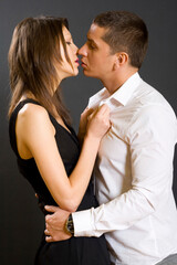 picture of a young couple kissing, studio shot