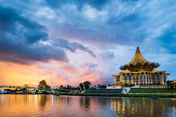 Kuching city waterfront sunset with river and landmarks in Sarawak, Malaysia.  - obrazy, fototapety, plakaty
