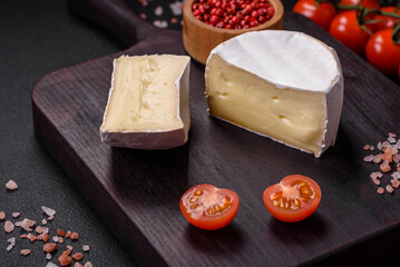 Delicious fresh brie cheese in the form of a mini head with cherry tomatoes